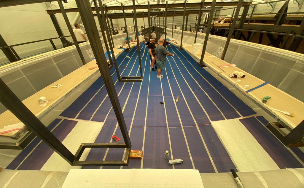 Laminators working inside a large composite mould