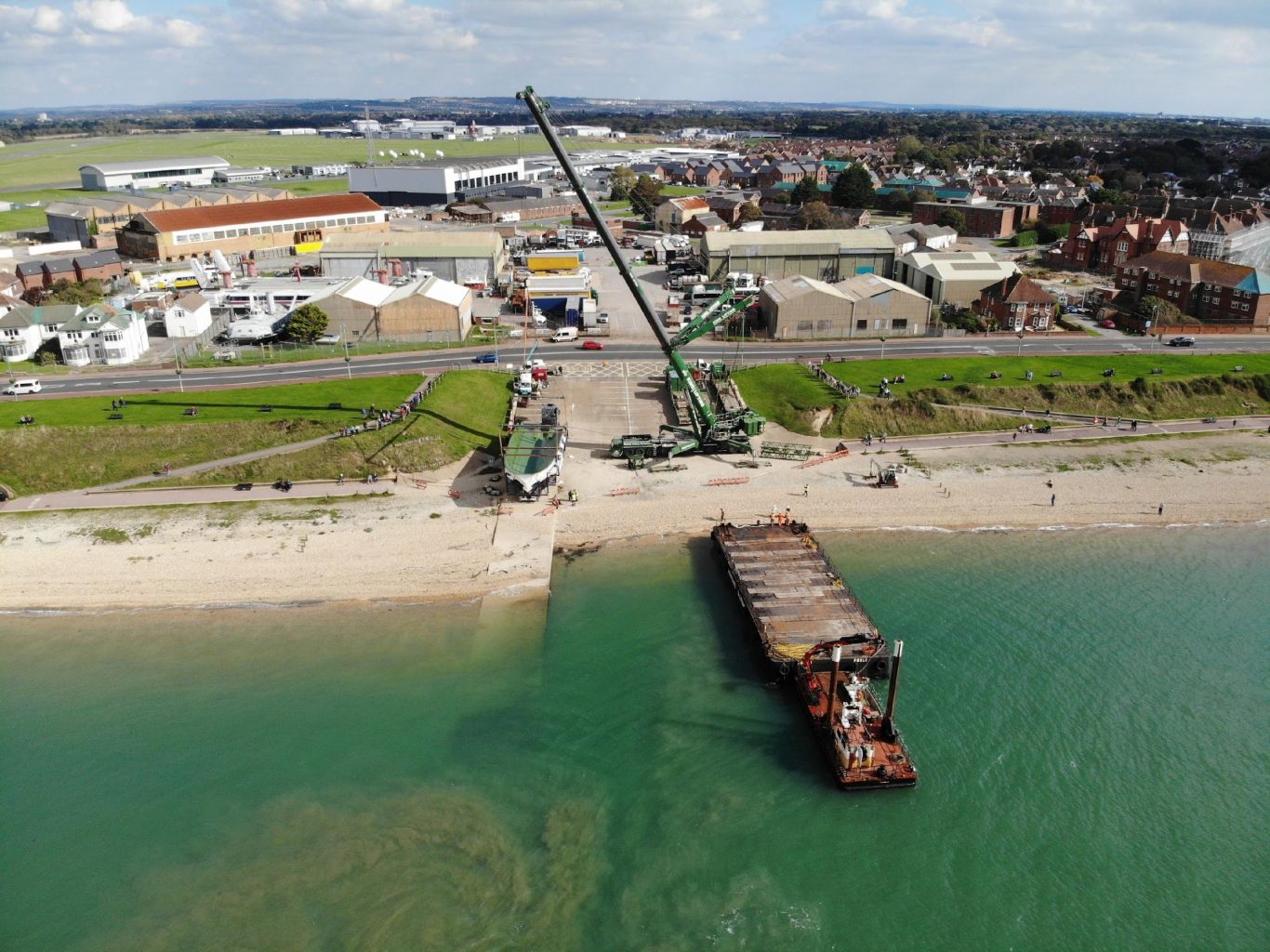 Lee-on-the-Solent site and slipway with a barge loading at the shoreline