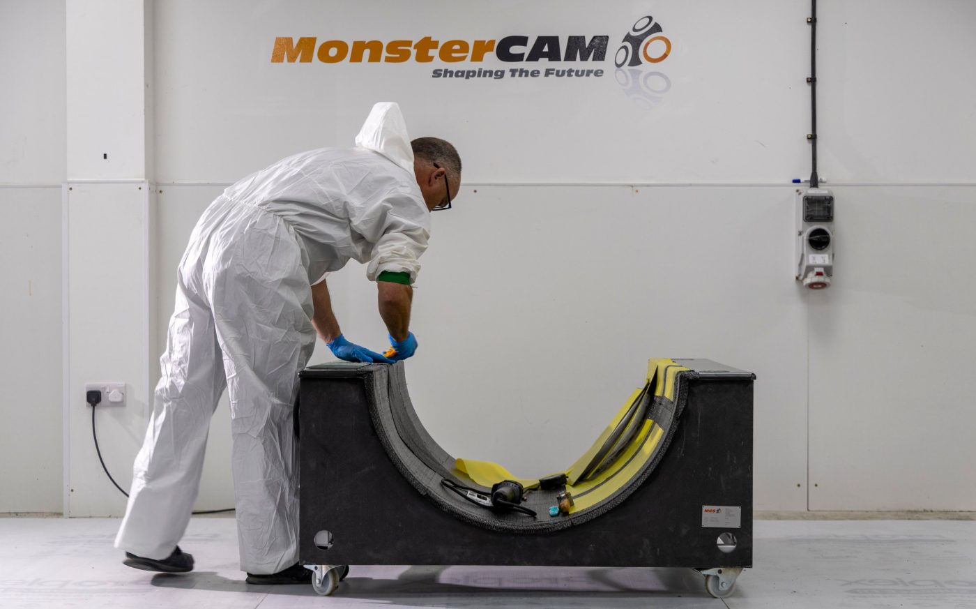 Laminator laying up prepreg in a composite mould